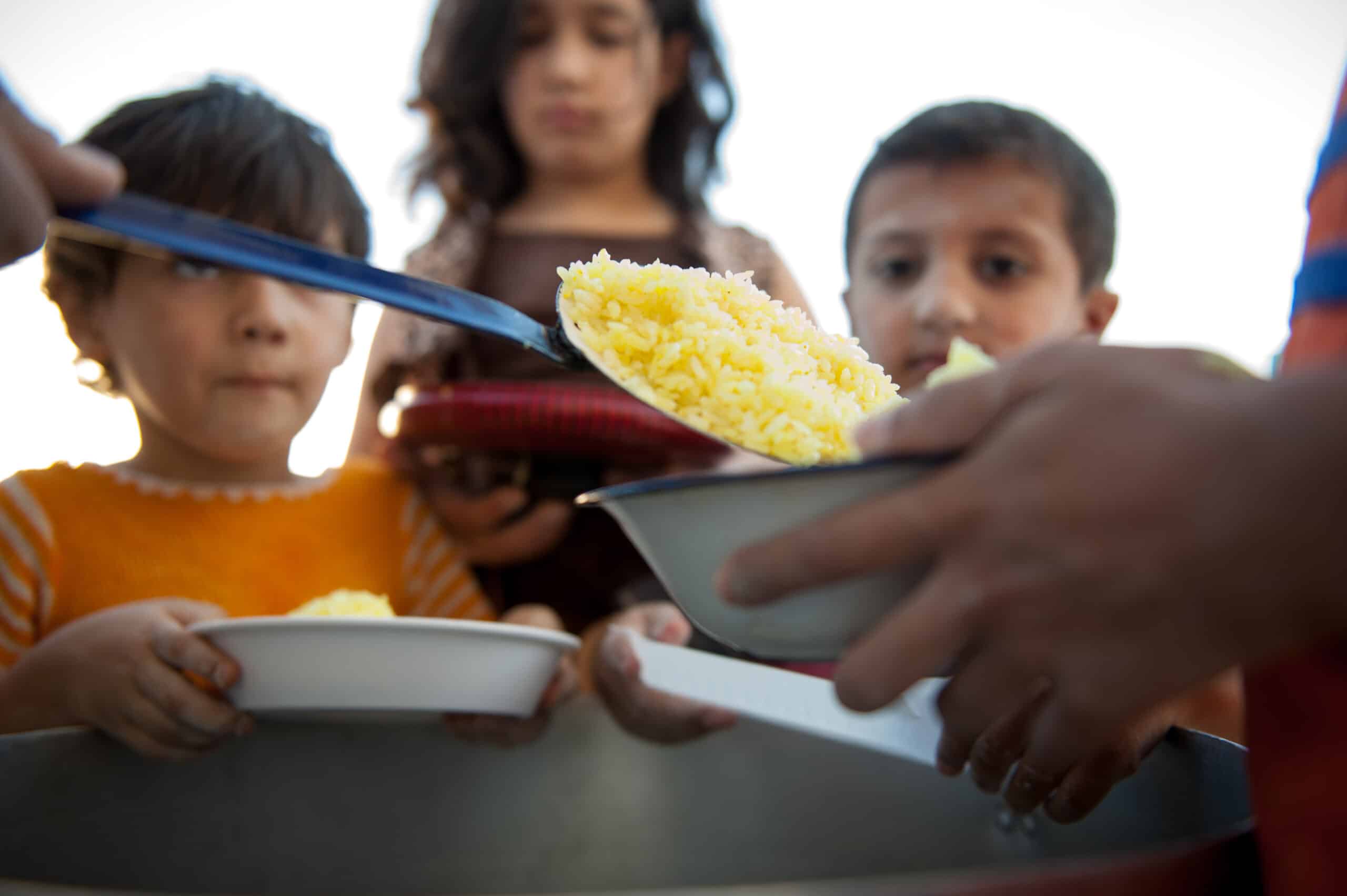 Children being served food from relief supplies